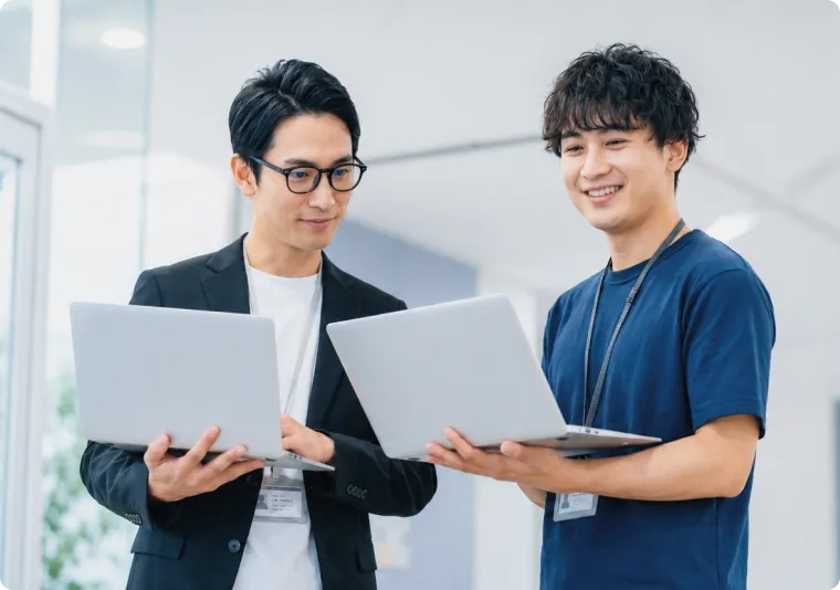 社員同士がノートパソコンを見ながら打ち合わせをしている様子